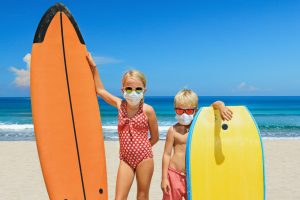 Kids enjoying Hawaii with masks