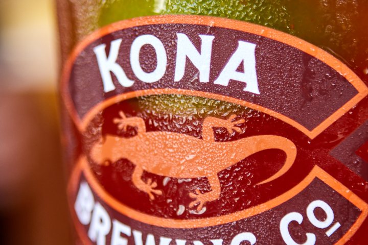 a close up of a bottle and a glass of beer kona brewery